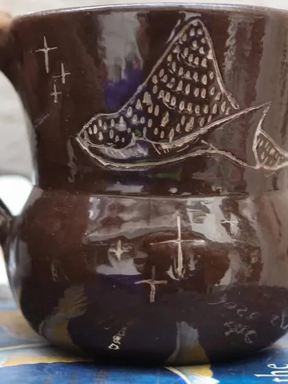 'The Lost Marines' is a set of three mugs I created using the Mishima technique on black clay. I carved the designs and inlaid them with white slip, creating a stark, beautiful contrast that I love.