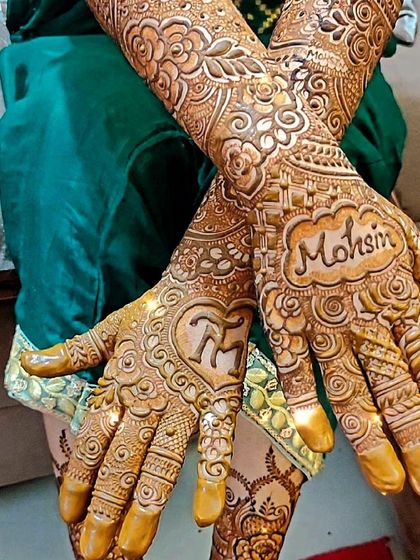 This bride wanted her groom's name, 'Mohsin', and their initials 'TM' included in her intricate bridal design.