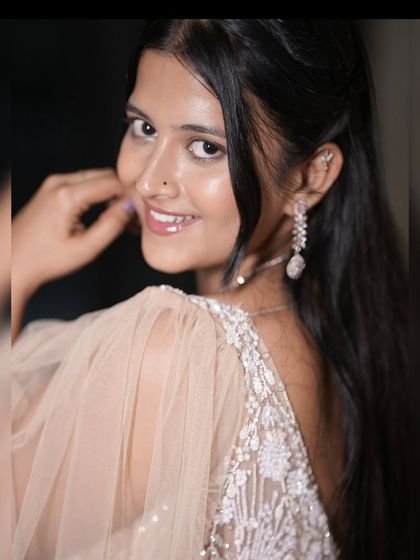 A happy close-up of our client in the peach rental gown.