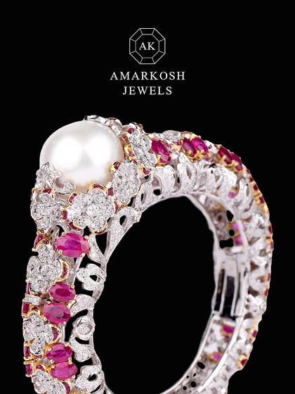 This stunning ring featuring diamonds, rubies, and a beautiful pearl is versatile and timeless.