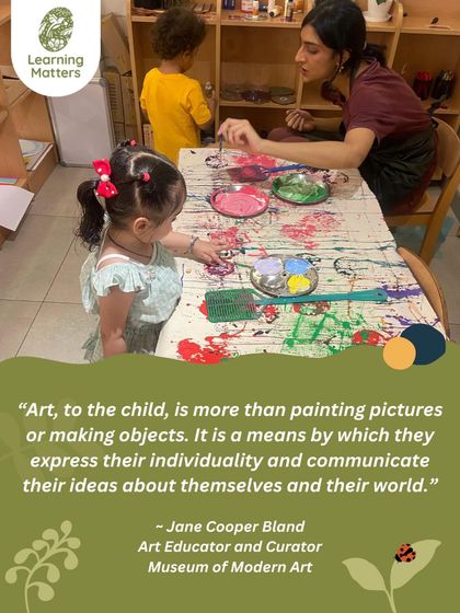 Art is a conversation between the child, the materials, and the educator. Here, a teacher observes and supports a child's exploration, ready to offer a new color or a word of encouragement, honoring the child's creative process.