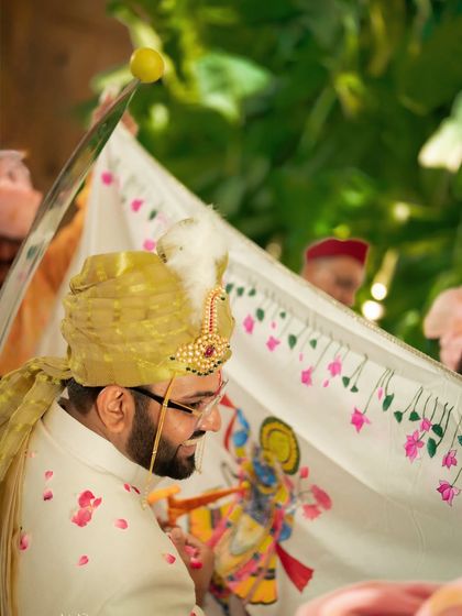 The groom during a traditional ritual, with a lemon balanced on his sword. We pay close attention to unique cultural details that make each wedding special.