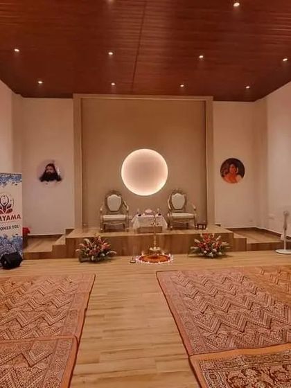 The meditation hall at our Bangalore centre, ready for a program. The clean wooden floors and traditional mats provide a comfortable and grounded space for practice.