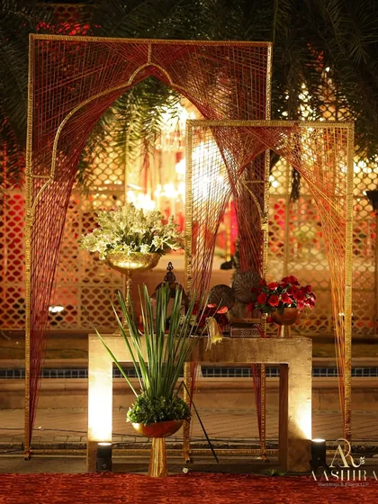 I love incorporating modern art into traditional designs. These custom thread-work arches added a contemporary touch to the entrance while maintaining the event's regal red and gold palette.