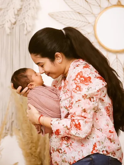 A mother's gentle touch and a baby's peaceful sleep. These are the quiet, intimate moments I aim to preserve during a newborn photography session.