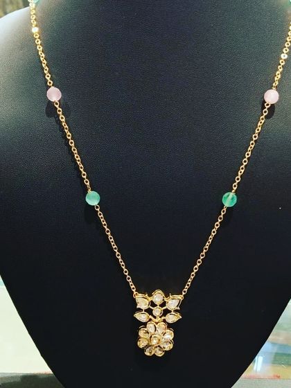 A lovely floral Kundan pendant on a simple chain with alternating pink and green beads. I can customize this design with any bead color you like.