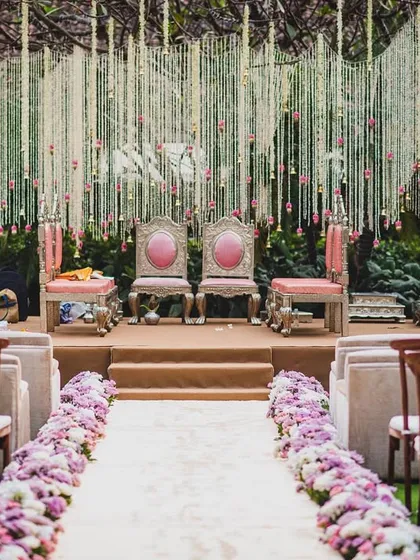 A full view of the 'Tree of Love' mandap for Jenita and Vinit. The design uses a natural champa tree as its foundation, adorned with thousands of hanging floral strings for a completely organic and breathtaking effect.