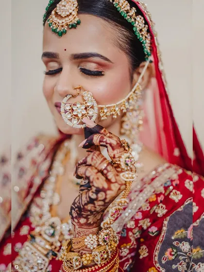 A close-up on the details. Notice the beautiful star-shaped nath and the soft, shimmery eye makeup that enhances her natural features.