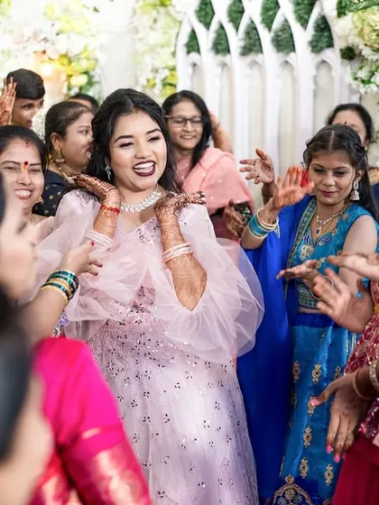 A wedding is a whirlwind of energy and emotion. We position ourselves to capture the unscripted joy, like this moment of the bride being surrounded by the infectious happiness of her friends and family on the dance floor.