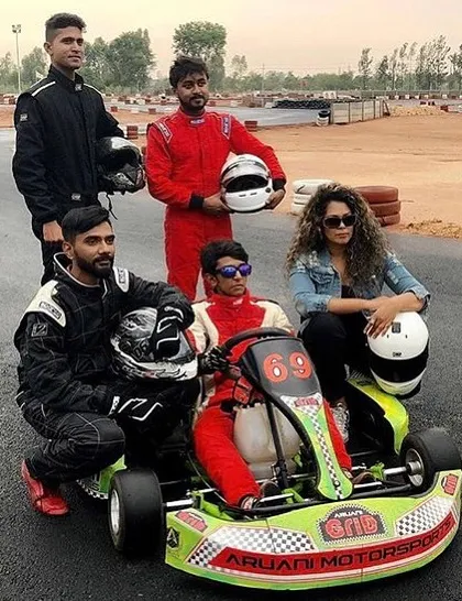 It's not just about racing; it's about the community. Here's a group of drivers posing with a kart after a session, sharing the excitement of a day well spent on the track.