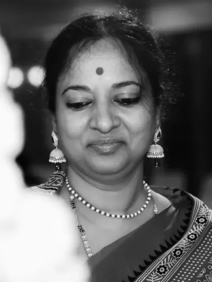 The same candid portrait in black and white. This version emphasizes the emotion and character in her expression, proving that sometimes color is a distraction from the real story.