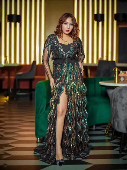A glamorous fashion shoot in a high-end cafe setting. I used the location's ambient lighting and decor to create a rich, moody atmosphere that complements the sequined gown.