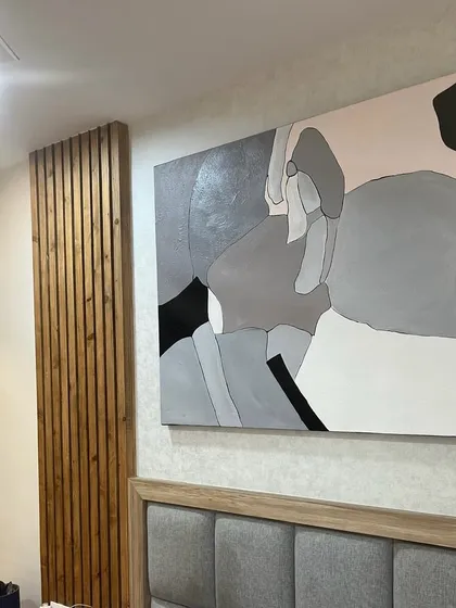 This 5ft x 4ft abstract painting was installed above the headboard in a Bangalore bedroom. The calming grey and neutral tones create a peaceful and modern ambiance, perfect for a restful space.