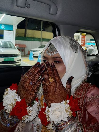 A candid shot of the bride, where the deep color of her henna stain is beautifully visible.