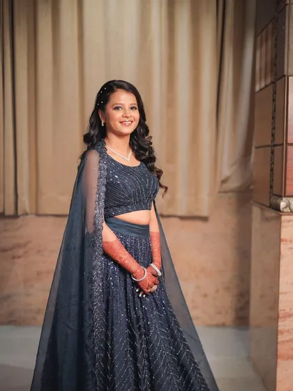A beautiful smile from this party guest. The makeup is soft and pretty, with a focus on glowing skin and a simple, elegant hairstyle.