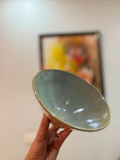 This two-toned bowl is a result of reduction firing, where parts of the bowl are oxidized while others are reduced. This creates a lovely mix of muted yellow and earthy blue.
