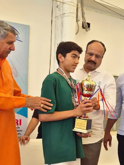 Aarez Asif receiving his Individual Champion trophy at the Haryana State Junior Aquatic Championship from the officials. A well-deserved honor.