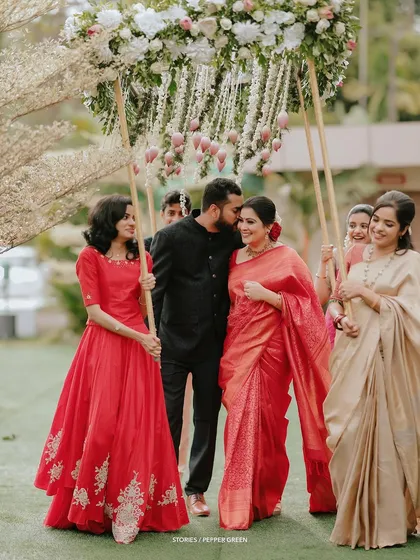 A tender moment as the groom, Antony, kisses his bride, Jesna, on the cheek during their procession. These small gestures of love are what make a wedding film so special.