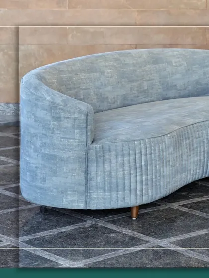 A closer look at the Ivy Sofa's elegant form. The gentle curve and textured fabric are designed to create a piece that is both a visual anchor and a haven of comfort, embodying our philosophy of furniture that feels as good as it looks.