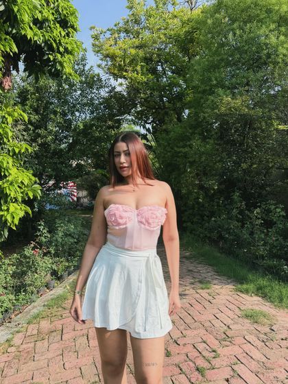 A romantic pink floral corset top paired with a white skort.