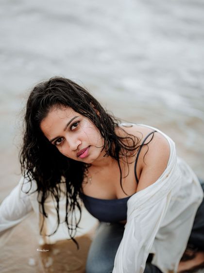 This shot captures a moment of vulnerability and strength. The water and wet look add a raw, elemental quality to the portrait.