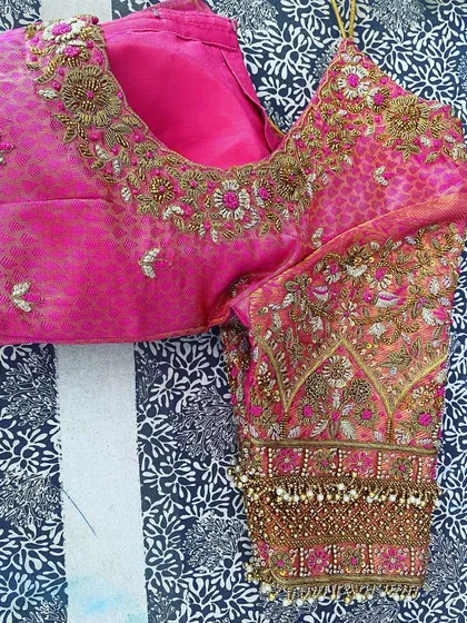 This is a close-up of my heavy sleeve embroidery. I combine different techniques like Zari, threadwork, and beads to create rich, textured patterns that are perfect for bridal wear.