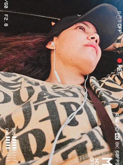 A candid, artistic shot in the same outfit, with a camera overlay effect.