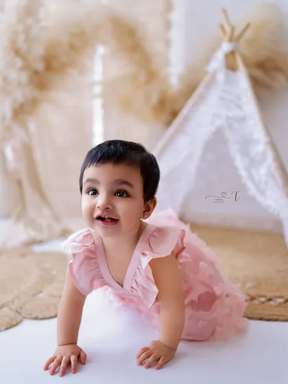Another angle of this adorable crawler, showing her determination and excitement. The soft pink dress adds a touch of sweetness.