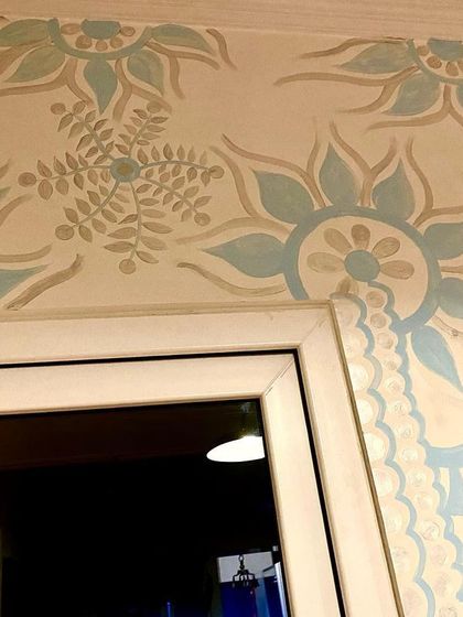 The mural design extending over the doorway. I love making the art interact with the architecture of the room, turning every corner into a part of the canvas.