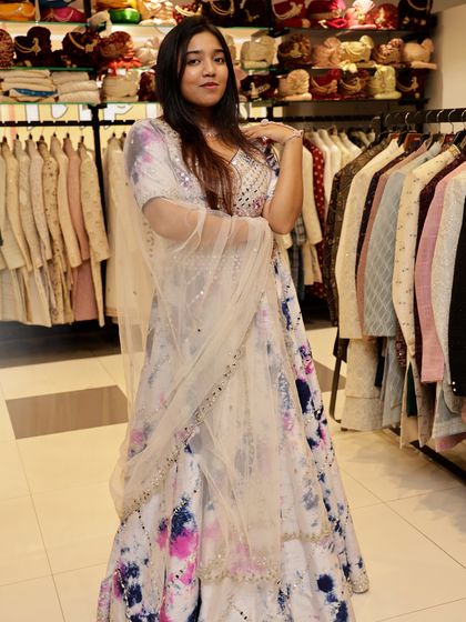 This full-length shot shows how the tie-dye lehenga flows. The lightweight fabric and bright colors make it a comfortable and stylish option for a summer wedding.