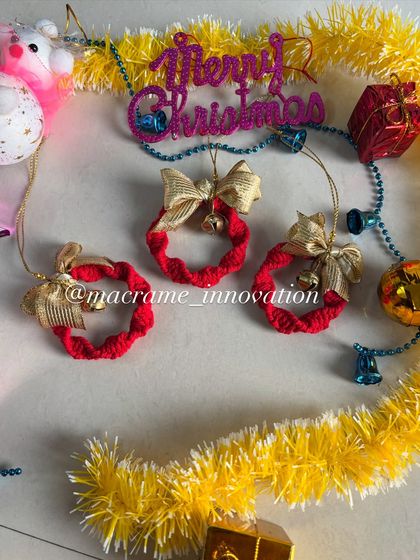 Tiny macrame wreaths with golden bows and bells. These classic ornaments bring a traditional, festive feel to your holiday decor.