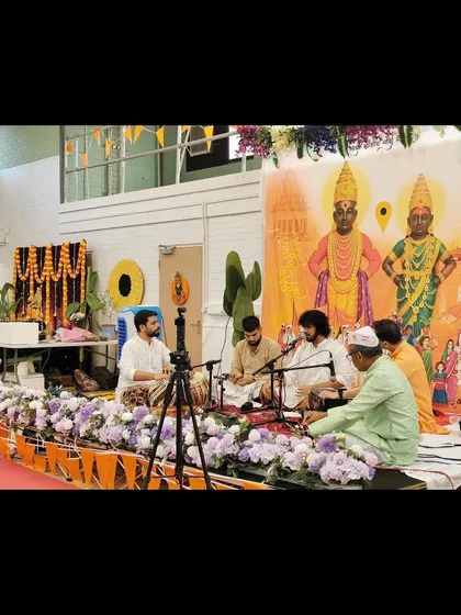 A wide shot of our performance for the Shree Vitthal Rukmini Temple Trust in the UK. The stage was beautifully decorated with images of the deities.