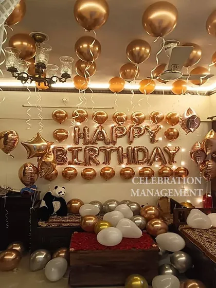 Another look at the rose gold setup, showing how the metallic balloons catch the light beautifully. A stuffed panda adds a cute and personal touch to the decoration.