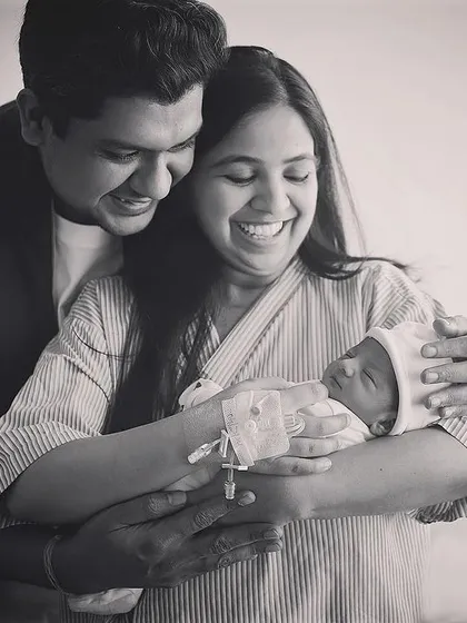 This is the kind of pure, unscripted joy I love to capture during a Fresh 48 hospital session. The happiness of new parents holding their baby for the first time is just magical. This black and white photograph focuses on the emotion and connection in this beautiful family moment.