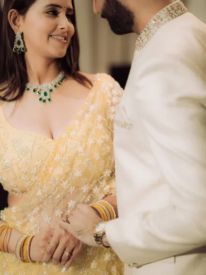 A close-up portrait focusing on the quiet intimacy between the couple. This shot highlights their elegant traditional attire and the gentle connection they share, perfect for an engagement album.