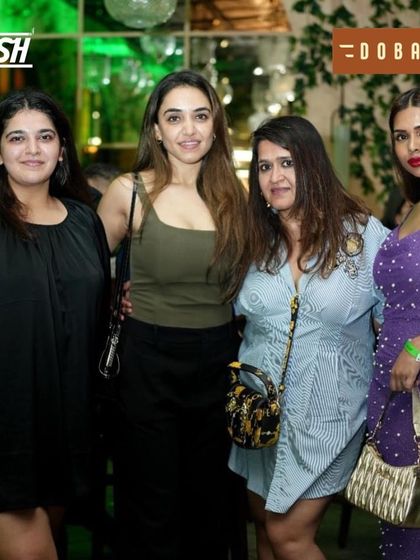 A stylish group of ladies posing for a picture at the Independence Day bash.