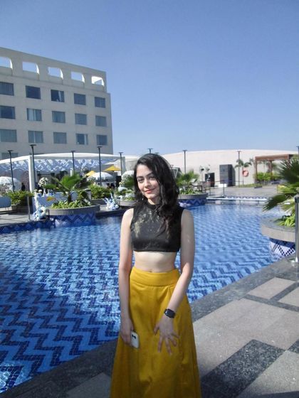 Full-length shot by the pool.