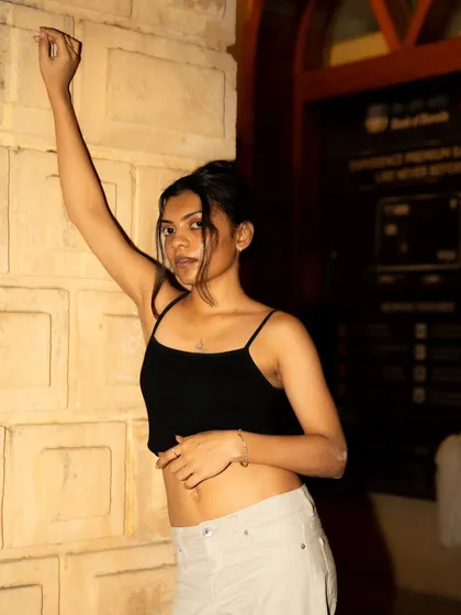 Taking the street shoot into the night. The warm light from a nearby building acts as a perfect key light for this simple, elegant pose.