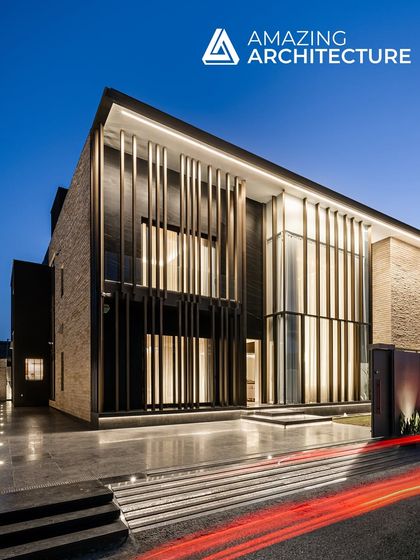 The Silhouette residence in Nawanshahr, featured in Amazing Architecture, uses vertical bronze louvers to create a facade that is both visually striking and private. At night, the home glows from within, revealing its double-height spaces.