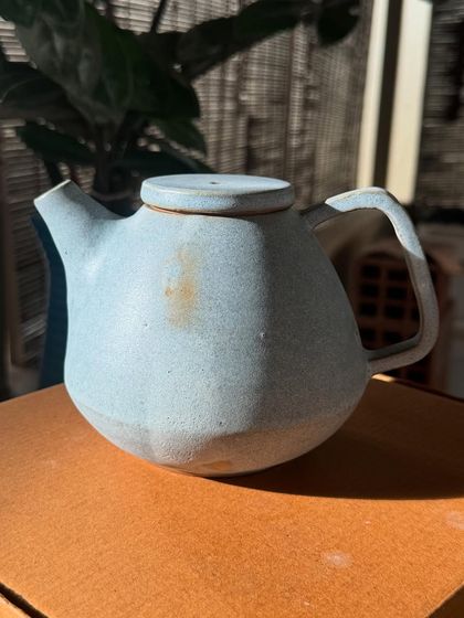 There is such elegance in simplicity. This wheel-thrown stoneware teapot has a calm, minimalist feel, with a beautiful pale blue glaze that has a subtle, speckled texture.