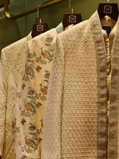 A closer look at the craftsmanship of our ceremonial wear. The collection features a variety of textures and patterns, including geometric and peacock-inspired motifs, all stitched with precision.