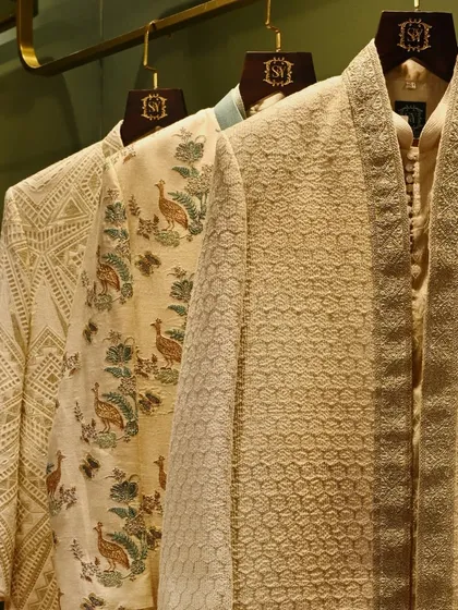 A closer look at the craftsmanship of our ceremonial wear. The collection features a variety of textures and patterns, including geometric and peacock-inspired motifs, all stitched with precision.