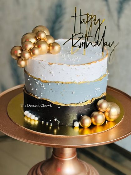 A modern and masculine design featuring a fault line style in black, grey, and white, accented with clusters of gold spheres.