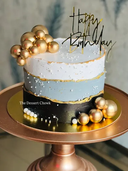 A modern and masculine design featuring a fault line style in black, grey, and white, accented with clusters of gold spheres.