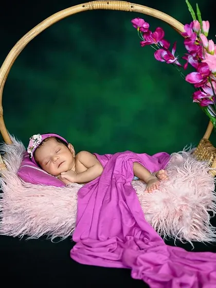 A variation of the hanging basket pose, this time with a green background that makes the purple wrap pop.