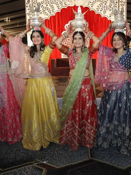 The joy of tradition. A group of women performing a ritual at a Mayra ceremony, all looking beautiful in their custom-designed, colorful lehengas.