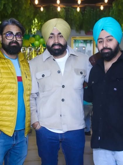 A group of three men posing for a photo at a party. Our event coverage includes capturing great shots of friends celebrating together.