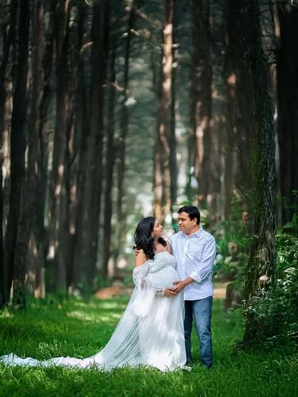 A breathtaking wide-angle shot of the couple in a dense, green forest. This photo emphasizes the journey they are on together, surrounded by the beauty of nature.