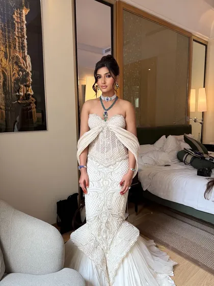 A full view of a bride ready for her reception. The sophisticated, high-volume updo I created balances the drama of her mermaid gown and ensures she looks regal throughout the evening.