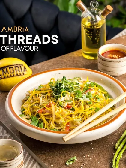 A comforting bowl of "Threads of Flavour" noodles, stir-fried with fresh vegetables and microgreens. A simple yet satisfying dish from our Pan-Asian selection.